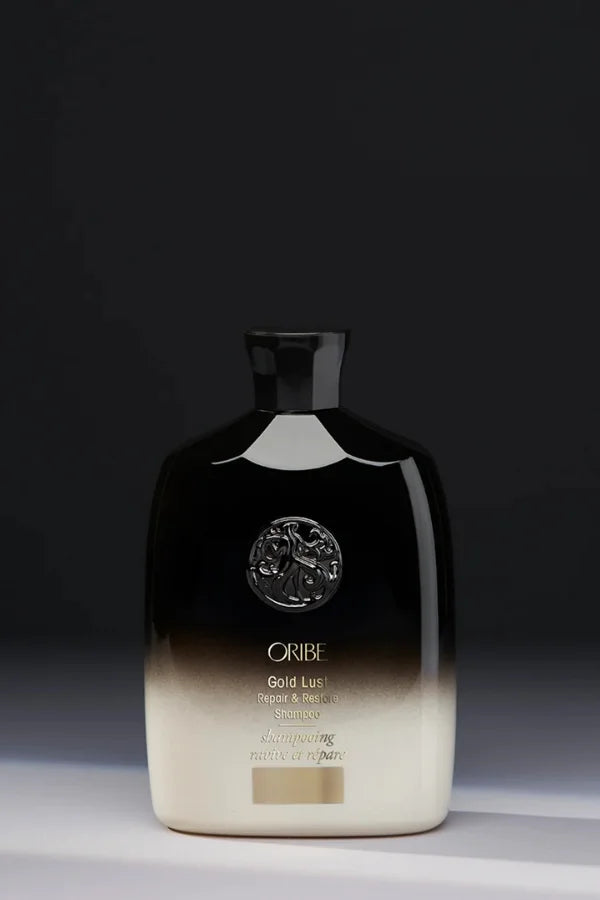 A standard 250 ml bottle of Oribe Gold Lust Repair and Restore Shampoo